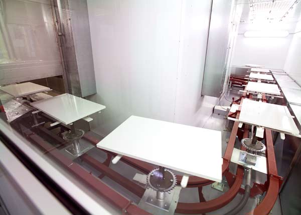 Cabinet doors on floor mounted conveyor system